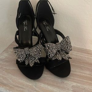 Beautiful black sueded high heel shoe  with a large encrusted metallic bow